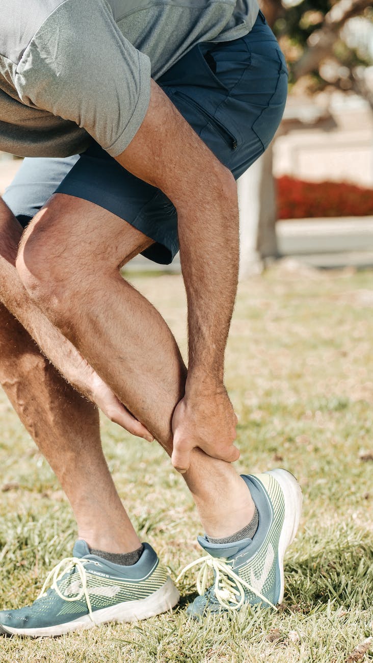 a man holding his lower leg